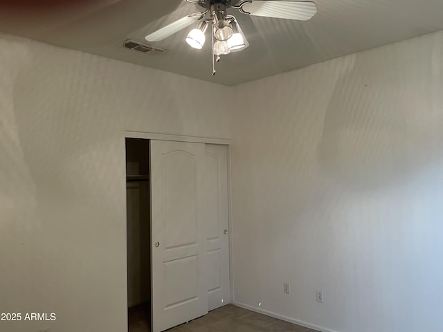 unfurnished bedroom featuring a closet, visible vents, and ceiling fan