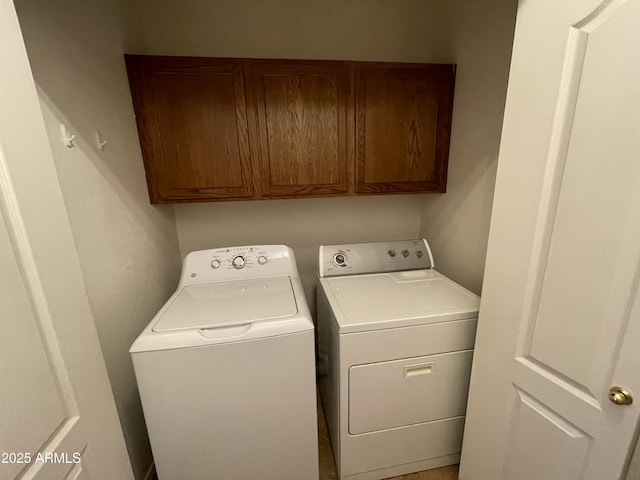 laundry area with washer and clothes dryer and cabinet space