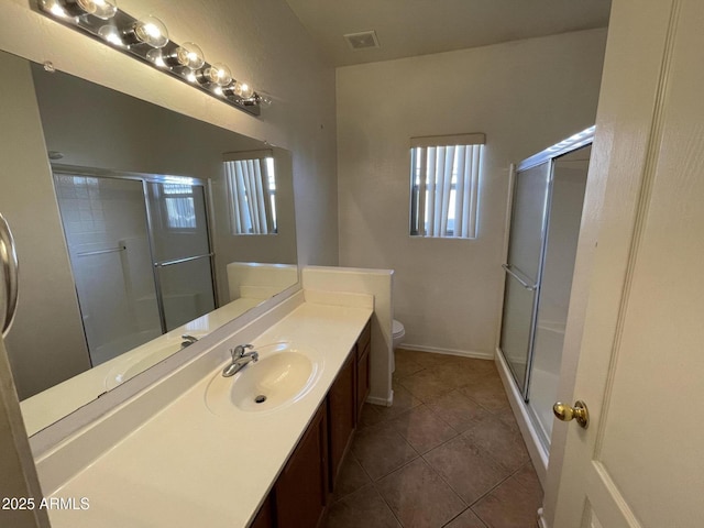 full bath featuring toilet, a shower stall, and vanity