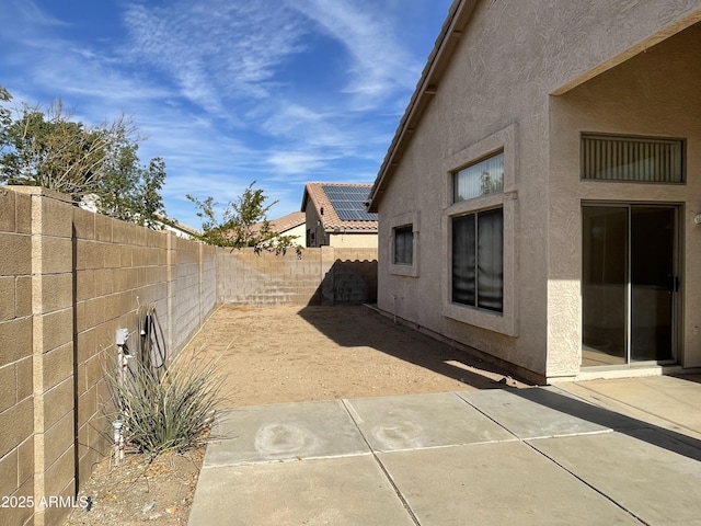 view of property exterior with a patio area, a fenced backyard, and stucco siding