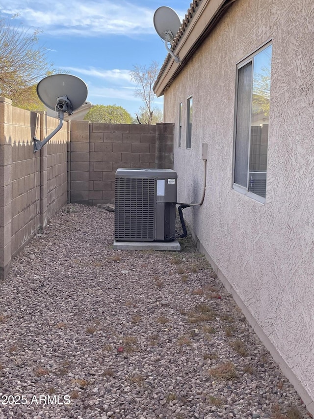 view of yard featuring central air condition unit and fence