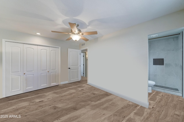 unfurnished bedroom featuring a closet, baseboards, light wood-style floors, and visible vents