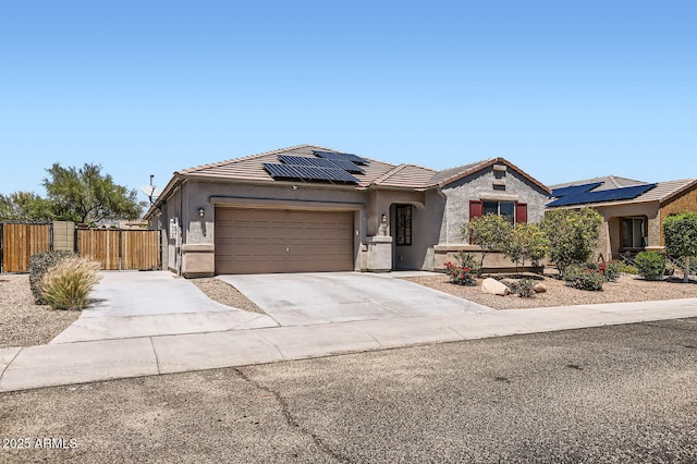 23730 W Hess Ave, Buckeye, AZ 85326 - view of front facade featuring a tiled roof, a gate, a garage, stucco siding, and solar panels