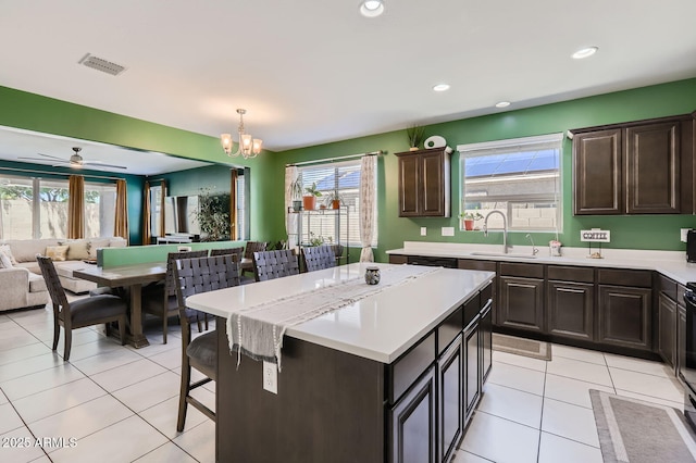23730 W Hess Ave, Buckeye, AZ 85326 - kitchen featuring a sink, plenty of natural light, light countertops, a kitchen island, and recessed lighting