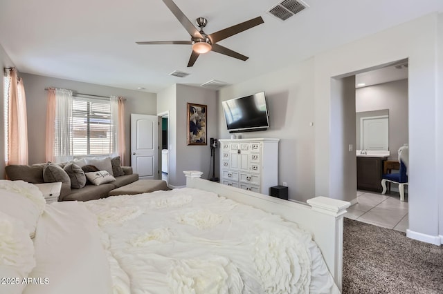 23730 W Hess Ave, Buckeye, AZ 85326 - carpeted bedroom with ceiling fan, tile patterned flooring, and baseboards