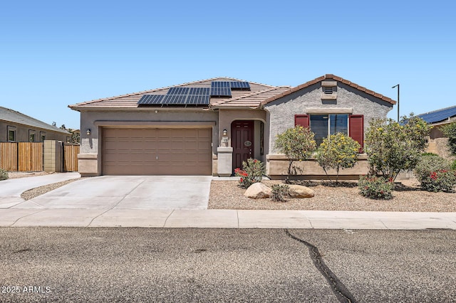 23730 W Hess Ave, Buckeye, AZ 85326 - view of front facade with roof mounted solar panels, an attached garage, a tiled roof, stucco siding, and concrete driveway
