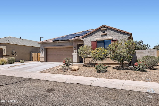 23730 W Hess Ave, Buckeye, AZ 85326 - view of front of house with an attached garage, roof mounted solar panels, a tile roof, concrete driveway, and stucco siding