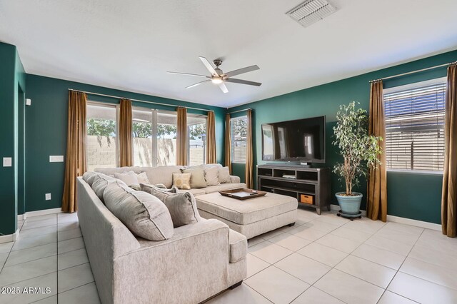 23730 W Hess Ave, Buckeye, AZ 85326 - living room with ceiling fan, light tile patterned flooring, and baseboards