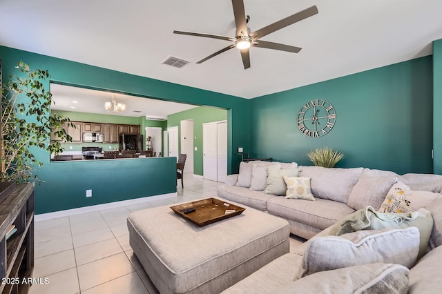 23730 W Hess Ave, Buckeye, AZ 85326 - living room featuring a chandelier, a ceiling fan, light tile patterned floors, and baseboards
