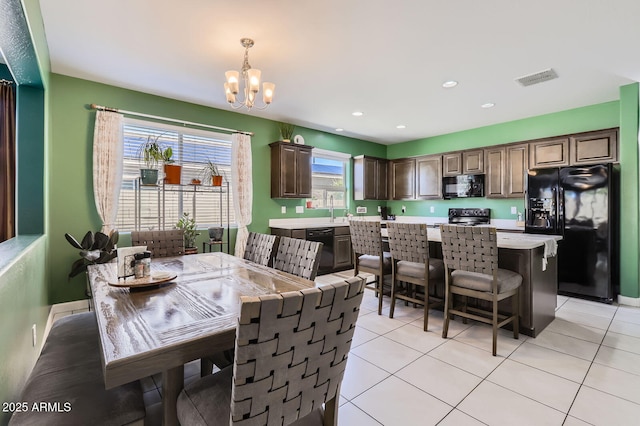 23730 W Hess Ave, Buckeye, AZ 85326 - dining room featuring a chandelier, recessed lighting, and light tile patterned floors