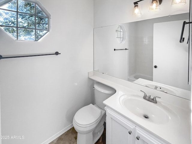 bathroom featuring vanity, toilet, and a shower