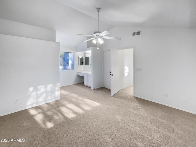 unfurnished living room featuring lofted ceiling, light colored carpet, and ceiling fan