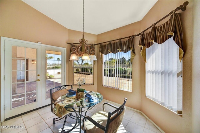 dining area with french doors and light tile patterned floors