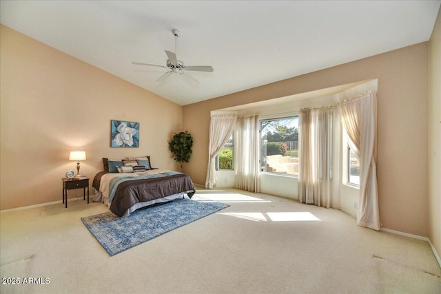 bedroom with ceiling fan, vaulted ceiling, and light carpet