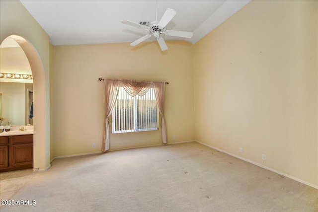 interior space featuring ceiling fan, light colored carpet, and connected bathroom