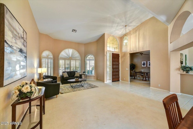 interior space featuring ceiling fan and high vaulted ceiling