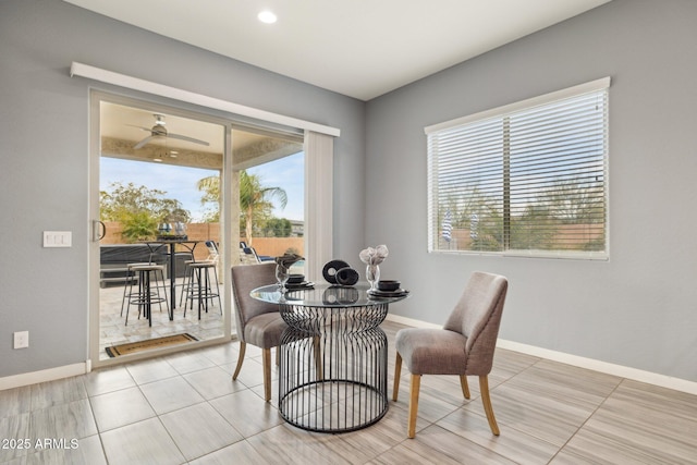 tiled dining room featuring baseboards and ceiling fan