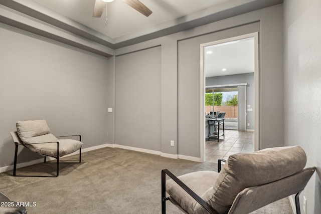 living area with light carpet, a ceiling fan, recessed lighting, light tile patterned floors, and baseboards