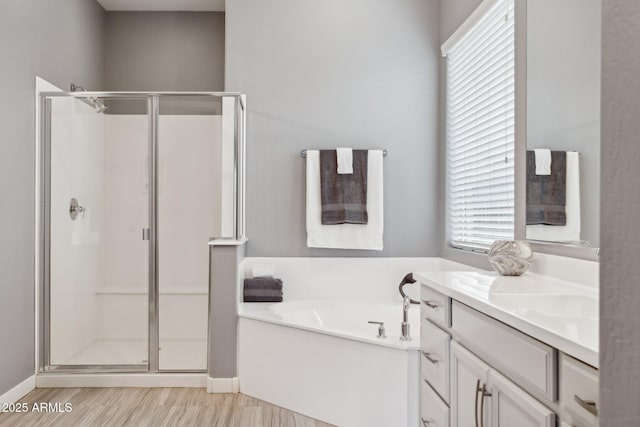 full bathroom featuring a garden tub, a stall shower, and vanity