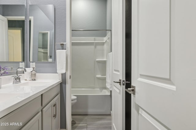 full bathroom with vanity, toilet, and shower / washtub combination