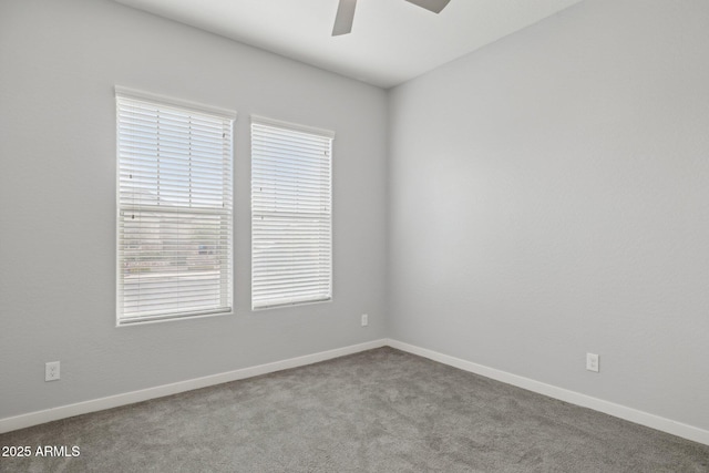 spare room featuring baseboards, carpet floors, and ceiling fan