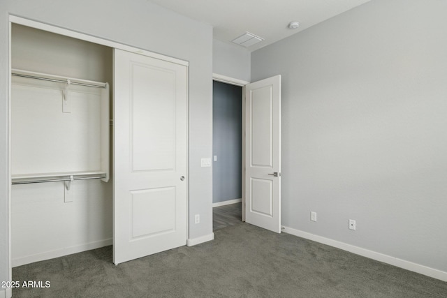 unfurnished bedroom with a closet, baseboards, and carpet floors