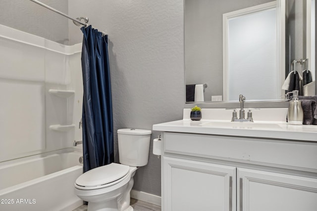 bathroom featuring baseboards, toilet, shower / tub combo, a textured wall, and vanity