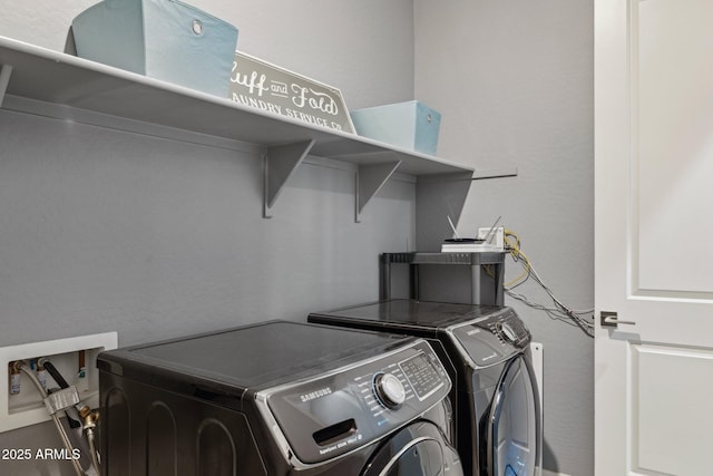 clothes washing area with laundry area and independent washer and dryer