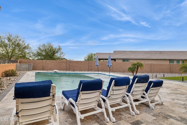 view of swimming pool with a patio area, a fenced in pool, and a fenced backyard