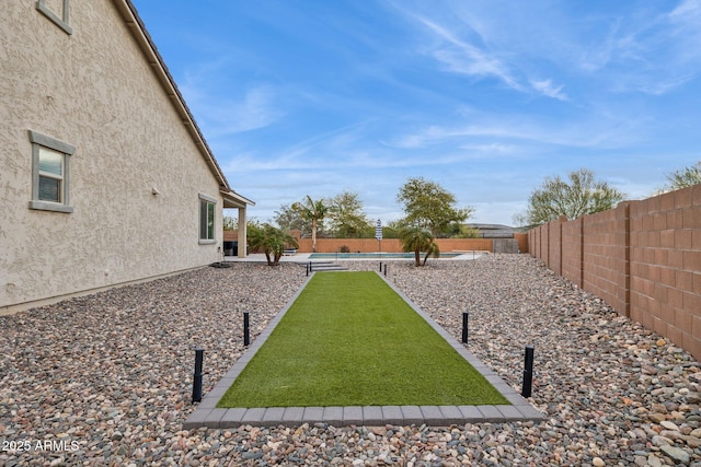 view of yard with a fenced in pool and a fenced backyard