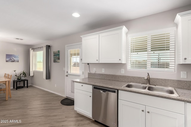 kitchen featuring a sink, visible vents, light wood-style floors, white cabinetry, and dishwasher