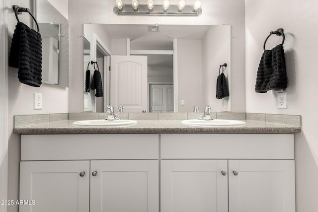 full bath with double vanity and a sink