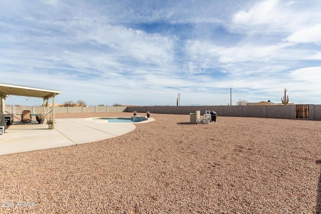 view of yard featuring a patio area, a fenced backyard, and a fenced in pool