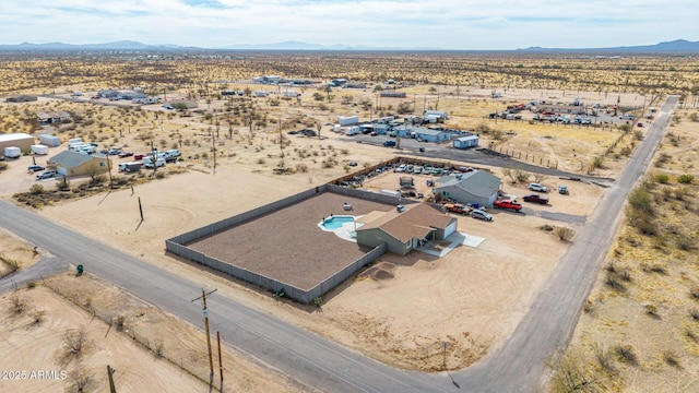 birds eye view of property with a mountain view and view of desert