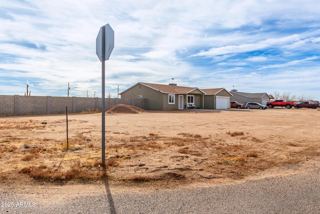 view of yard with an attached garage and fence