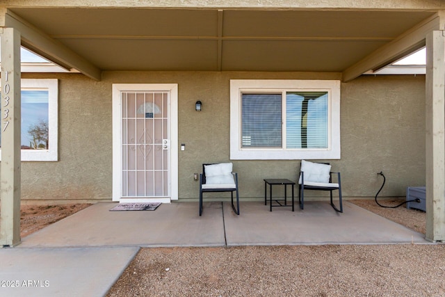 entrance to property with stucco siding