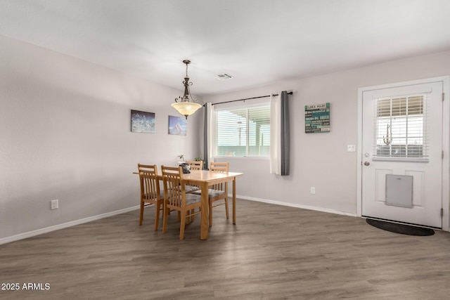 dining room with visible vents, baseboards, and wood finished floors