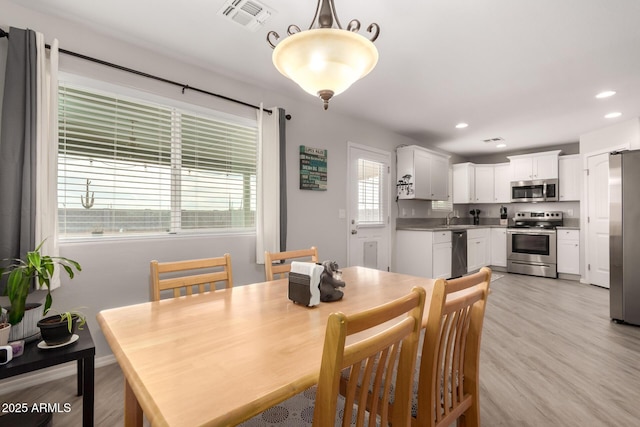 dining area with recessed lighting, visible vents, and light wood finished floors