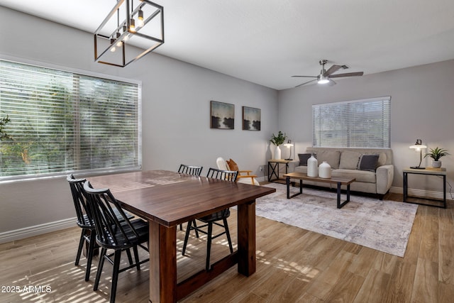 dining space with ceiling fan and light hardwood / wood-style floors