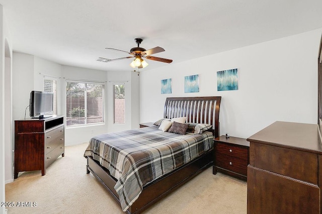 bedroom with light carpet and a ceiling fan