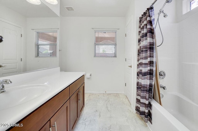 bathroom with vanity, marble finish floor, visible vents, and plenty of natural light