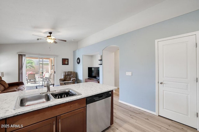 kitchen featuring open floor plan, dishwasher, a sink, and a ceiling fan