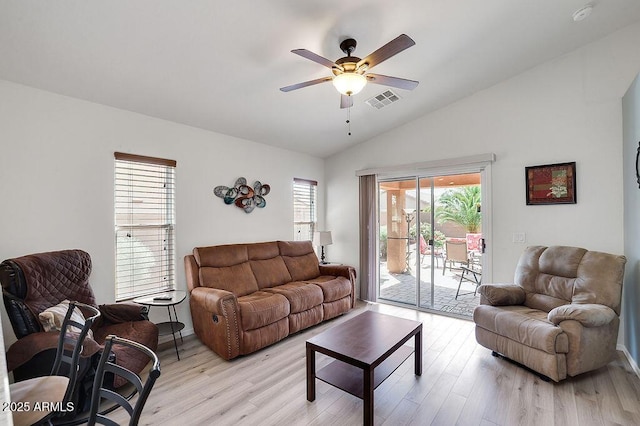 living area featuring light wood-type flooring, ceiling fan, vaulted ceiling, and visible vents