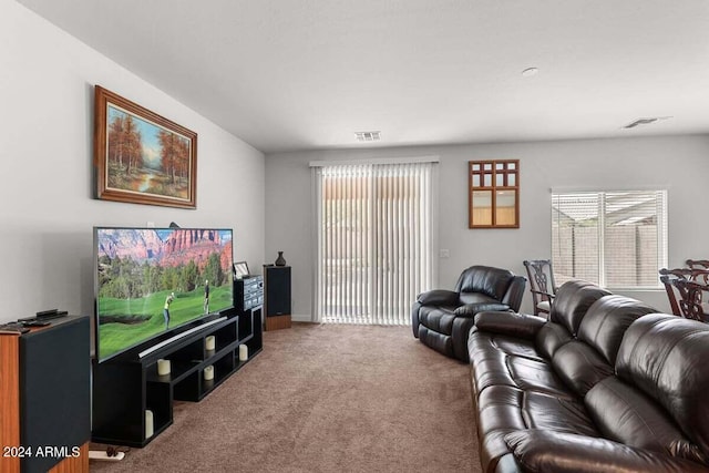 living area featuring carpet floors and visible vents