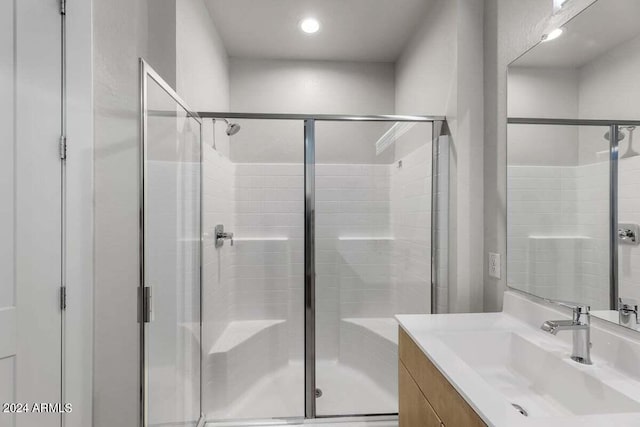 full bathroom with recessed lighting, a shower stall, and vanity