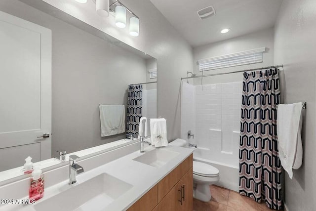 bathroom with toilet, a sink, visible vents, and tile patterned floors