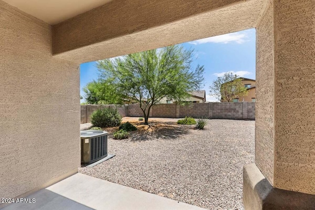 view of yard with a fenced backyard, a patio, and central AC unit