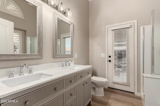 8319 E Plata Ave, Mesa, AZ 85212 - bathroom featuring wood finished floors, toilet, plenty of natural light, and double vanity