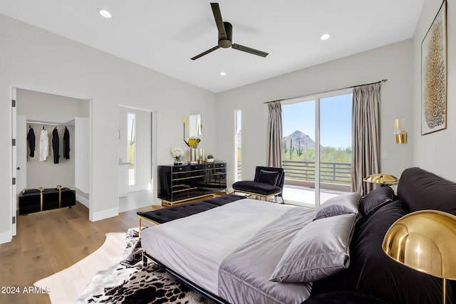 bedroom featuring hardwood / wood-style floors, ceiling fan, and access to outside