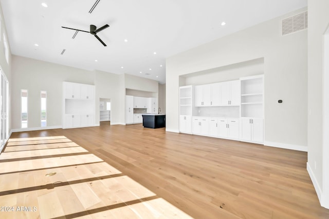 unfurnished living room with light hardwood / wood-style floors and ceiling fan